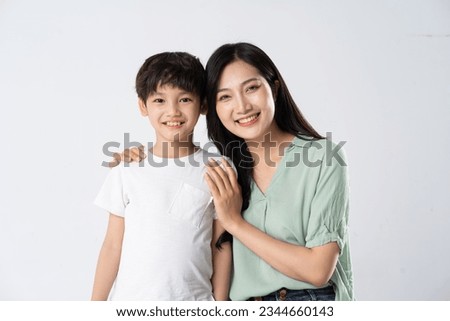 mother and son posing on a white background Royalty-Free Stock Photo #2344660143