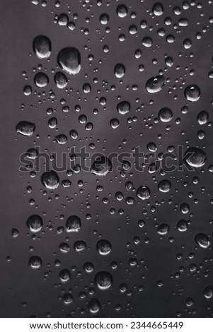Water drops and reflections on black metal - Dark background