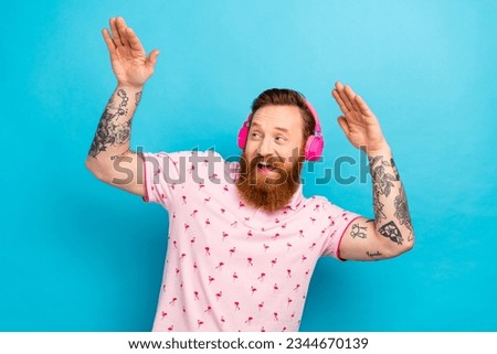 Portrait of cheerful excited person good mood enjoy listen favorite playlist arms dancing isolated on blue color background Royalty-Free Stock Photo #2344670139