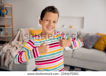 Closeup photo of young small school boy double thumbs up positive good mood enjoy spend time playroom isolated on blurred background