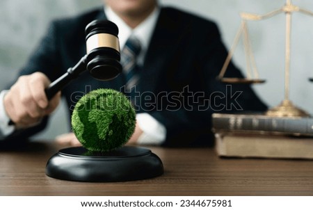 Judge hold wooden gavel with golden scale and globe for law international environmental concepts of business corporate and industry. law world environmental regulation.sustainable environment concept Royalty-Free Stock Photo #2344675981