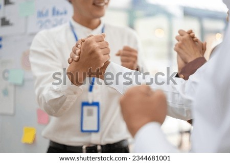 Close-up image of a businessman making a strong powerful handshake with his business partner in a meeting. partnership, support, teamwork, togetherness