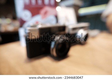 Blur focus of old camera on a wooden table