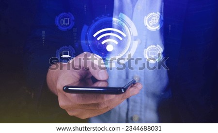 Businessman using smartphone with wifi icon. Social network business communication concept, Wifi wireless concept free network Internet concept. Royalty-Free Stock Photo #2344688031