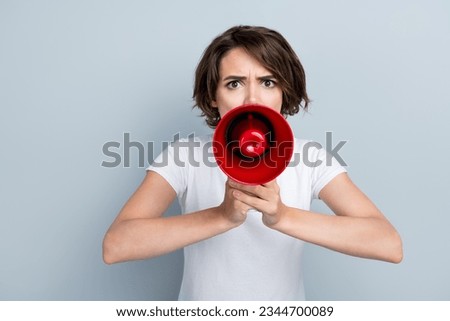 Photo of aggressive mad serious woman with short hairdo dressed white t-shirt shouting in megaphone isolated on gray color background Royalty-Free Stock Photo #2344700089
