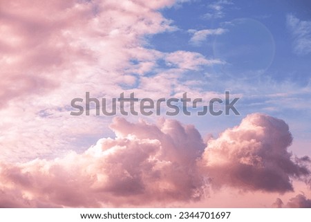 Beautiful fabulous pink cumulus clouds in the blue sky at sunset. natural background Royalty-Free Stock Photo #2344701697