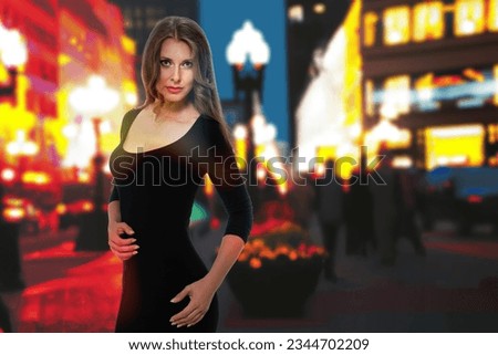 Beautiful slim blonde young woman wearing black dress posing on night city street, Night cityscape: elegant blonde lady in black dress striking a pose