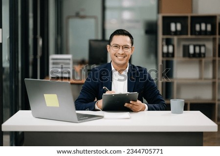 Attractive young lawyer in modern office Business man and lawyers discussing contract papers laptop and tablet with brass scale on  desk in modern office. Law, legal services, advice,

