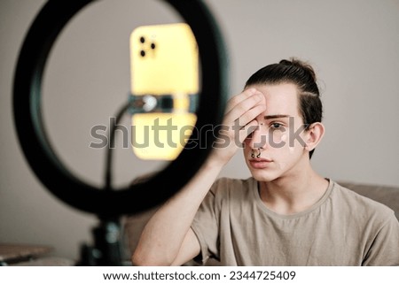 Gay man recording a video while making up