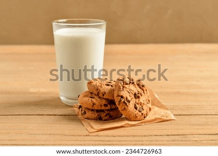 Tasty cookies with chocolate chips and glass of milk on table Royalty-Free Stock Photo #2344726963