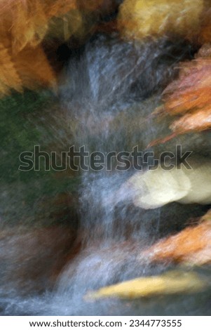 Autumn forest in motion blur. Abstract background with blurred leaves.