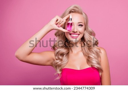 Photo of pretty lovely girly lady hold show serum bottle for everyday face hygiene hydration on pink background