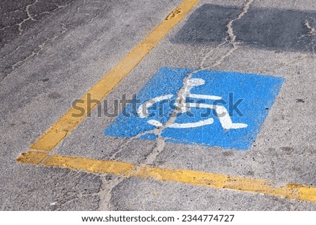 Traffic signs for disabled parking on the cracked asphalt