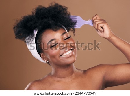 Comb, hair care or happy black woman with afro, self love or smile on a brown studio background. Hairstyle, healthy growth or African model with natural shine or beauty with aesthetic or wellness Royalty-Free Stock Photo #2344790949