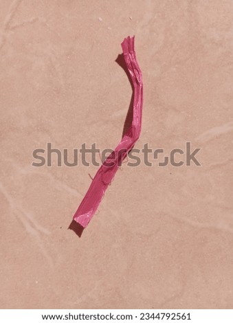 a rope of rope called a tali rafia which has a red color is placed on the floor in the morning Royalty-Free Stock Photo #2344792561