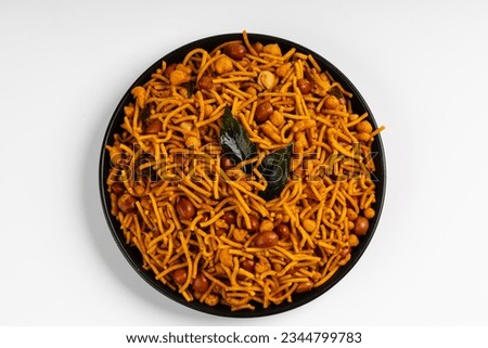 MIXTURE , commonly known as "Chivda" or "Namkeen," is a popular and delicious savory snack in India, a mixture of various crunchy and flavorful ingredients,  Royalty-Free Stock Photo #2344799783