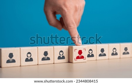Human resource management, HRM and recruitment for business build team concept. Close up hand choosing man people icons on wooden cube blocks in oblique alignment. Hiring joining career opportunity. Royalty-Free Stock Photo #2344808415