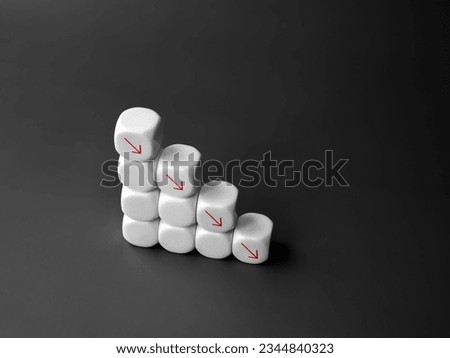 Red down arrows on white blocks stacked, decrease business graph down step, finance diagram on dark background. Financial crisis, bankruptcy, loss investment economic recession sales risk concepts.