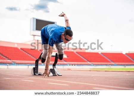 Asian para-athletes disabled with prosthetic blades running at stadium. Attractive amputee male runner exercise and practicing workout for Paralympics competition regardless of physical limitations Royalty-Free Stock Photo #2344848837