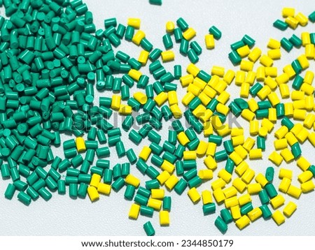 cold cut type green and yellow masterbatch granules on a white background, this material is used as a product coloring agent in the plastics industry Royalty-Free Stock Photo #2344850179