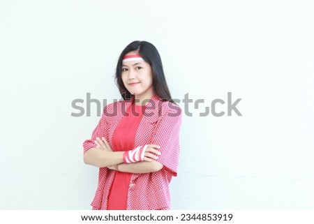 portrait of an asian woman wearing a red outfit celebrating Indonesia's independence day isolated on white background. soft focus.
