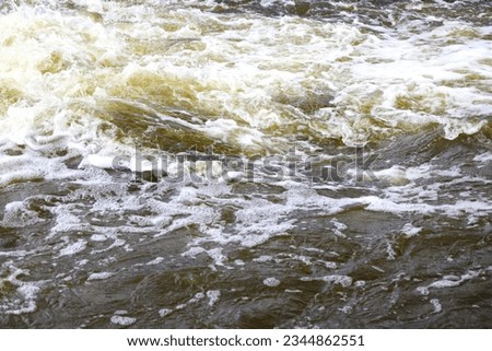 The foaming water of a rushing river.
