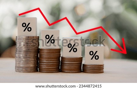 Percentage sign on wooden cubes with Stack of coin bar chart and red graph trending downwards on nature background. Economy recession crisis, inflation, stagflation,business and financial loss concept Royalty-Free Stock Photo #2344872415