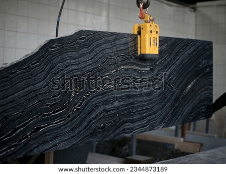 Picture of a marble slab on a hanger, shot in natural light, a cut of decorative marble in a warehouse, a large piece of marble