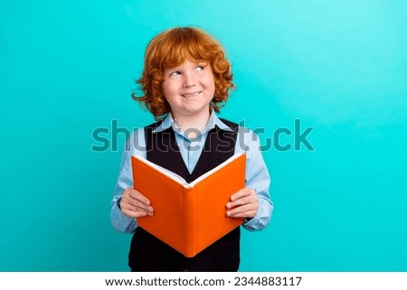 Photo of minded little person arms hold opened book look empty space contemplate isolated on teal color background
