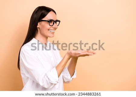 Photo of brunette hair attractive good mood worker businesswoman holding arms presentation object isolated on beige color background