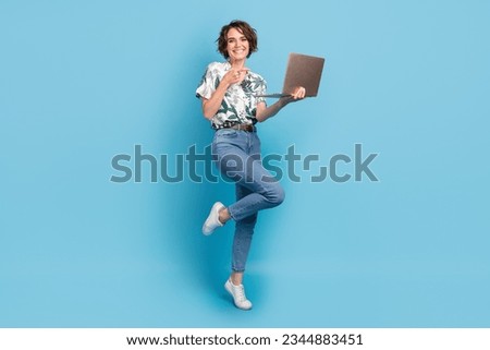 Full length photo of cheerful cute woman dressed print shirt pointing finger modern device isolated blue color background Royalty-Free Stock Photo #2344883451