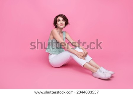 Full body length photo of dreaming cute girl looking empty space thoughts about her boyfriend sit floor isolated on pink color background