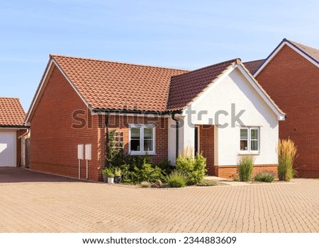 New build modern detached bungalow with block paved driveway. UK Royalty-Free Stock Photo #2344883609