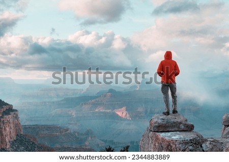 Traveler on cliff mountains over Grand Canyon National Park, Arizona, USA.Inspiring emotion. Travel Lifestyle journey success motivation concept adventure  vacations outdoor concept. Royalty-Free Stock Photo #2344883889