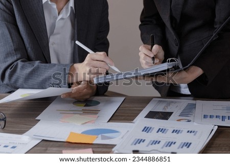 Team of businesswoman working with analysis financial data visualization tech for marketing strategy, Businesswoman accountant or financial report graph at desk in corporate office. 