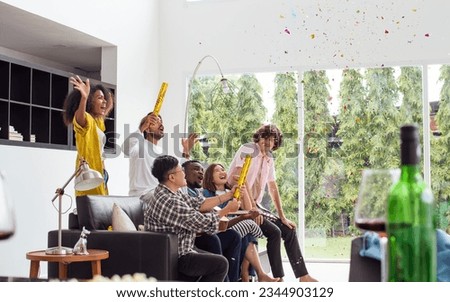 Diverse friends or people wearing casual clothes, Paper shooting for party celebration, sitting in living room at cozy home, happily playing guitar, screaming, singing. Birthday, New Year Concept