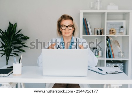 Female doctor make online video call consult patient on laptop. Middle aged woman therapist videoconferencing for domestic health treatment. Telemedicine concept. Online remote medical appointment Royalty-Free Stock Photo #2344916177