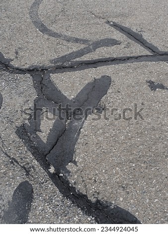 repairing cracks on the asphalt road, close up of photo