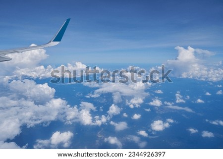 Aerial view seen over clouds, from modern aircraft at daytime.