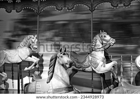 horses carousel, merry-go-round, speed effect Royalty-Free Stock Photo #2344928973
