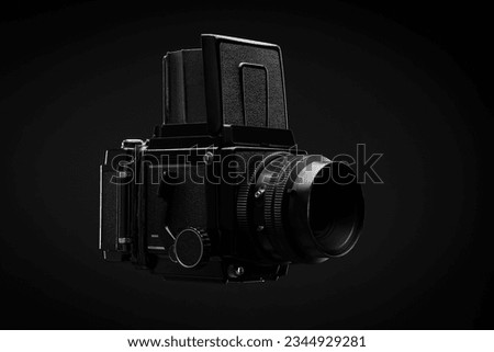 Medium format professional film camera over black background