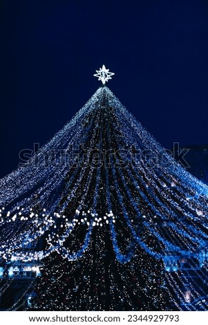 Silver blue magic twinkling bokeh lights of Christmas tree. New Year vertical festive background