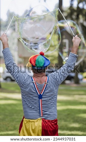 clown blowing soap bubbles at a children's party