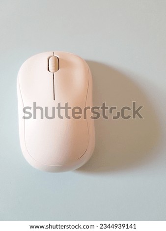 A sleek wireless mouse, its shape minimal, captured in mouse pictures, a modern tool for seamless computer control.