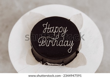 Happy birthday round chocolate cake top view. High quality photo