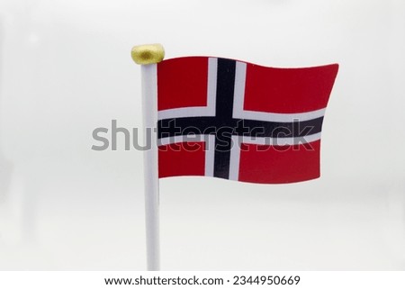 Closeup of a wooden table decoration featuring the Norwegian flag. Isolated on white. 