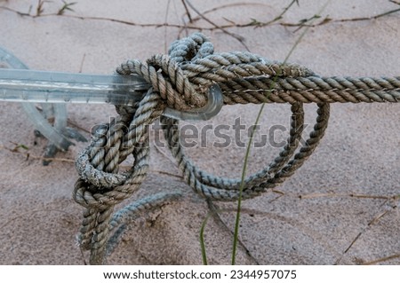 Blue rope tied with knots in the dunes