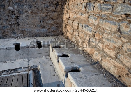 Ephesus ancient city open-air museum. Ephesus is one of the largest Roman archaeological sites in the eastern Mediterranean. Ancient Roman latrines. Izmir,TURKEY. Royalty-Free Stock Photo #2344960217