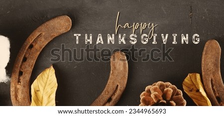 Happy Thanksgiving flat lay with rustic horse shoes banner background for holiday celebration.