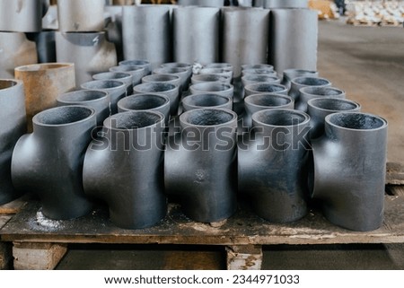 Batch of T shape pipe parts in warehouse.